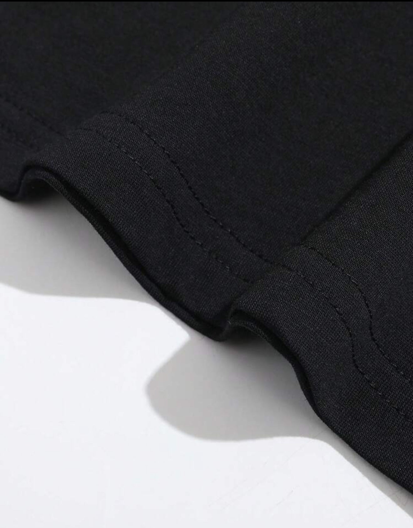 black t-shirt features a detailed cat illustration