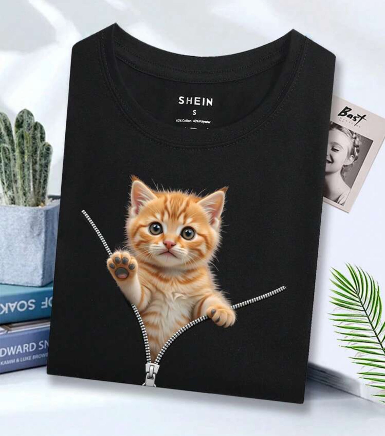 black t-shirt features a detailed cat illustration